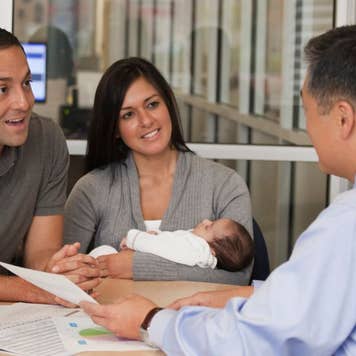 Couple speaking with a financial advisor