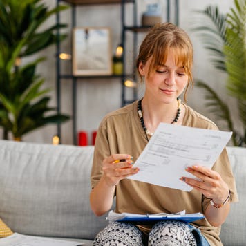 Young Woman Checking Her Finances At Home