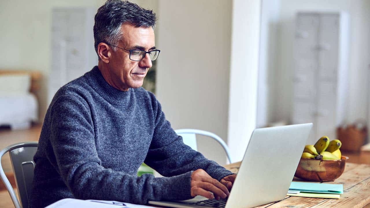 Shot of a senior man using a laptop at home